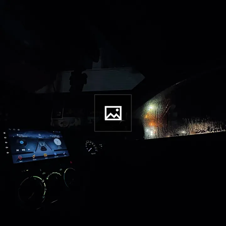 Car dashboard at night in rain