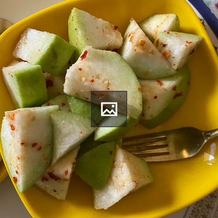 Green guava slices in yellow bowl