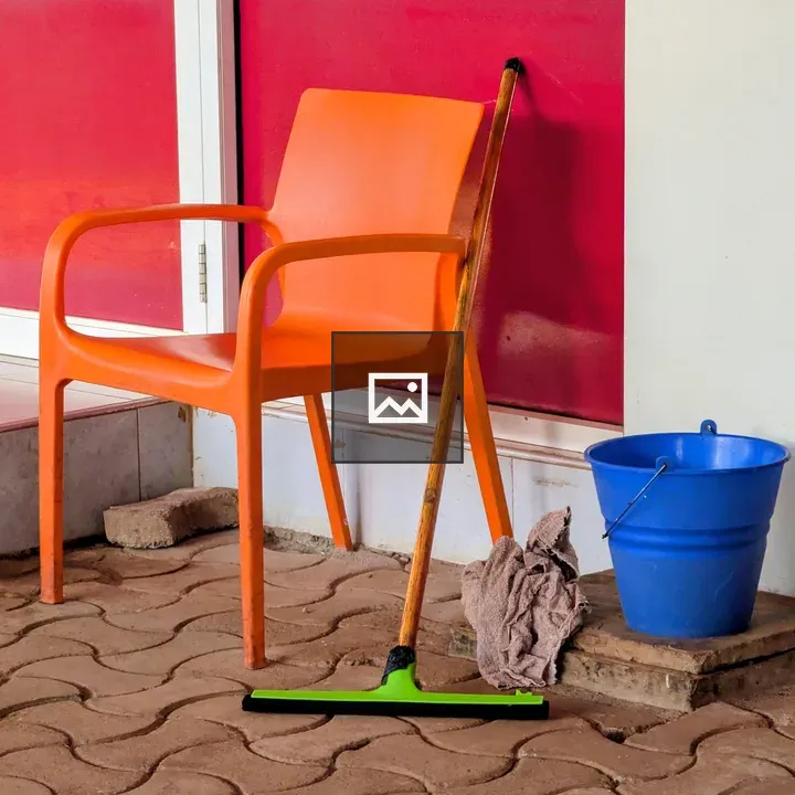 Orange chair beside blue bucket