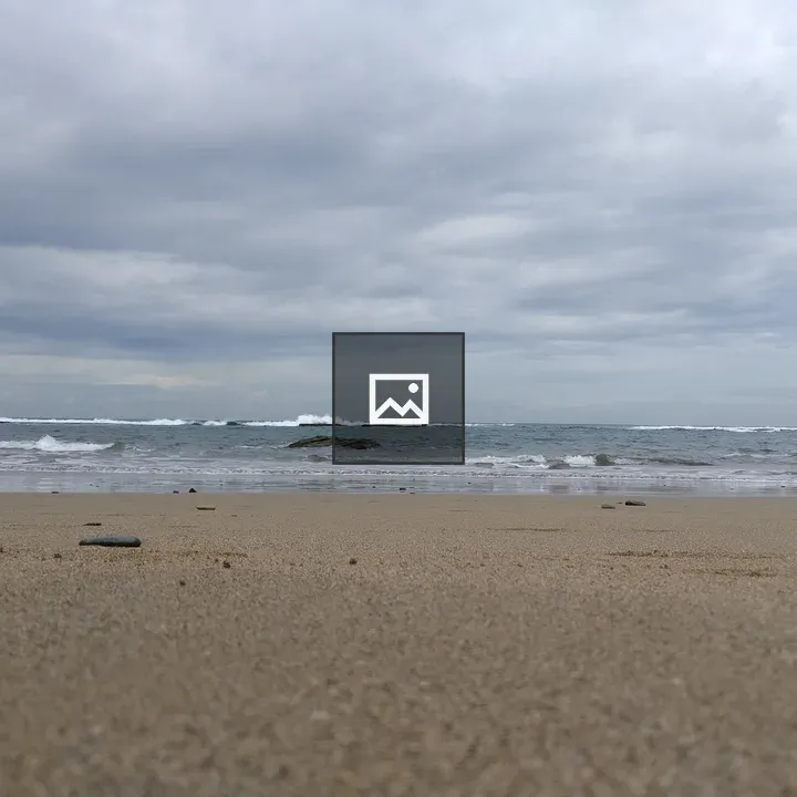 Beach with Pebbles and Calm Ocean