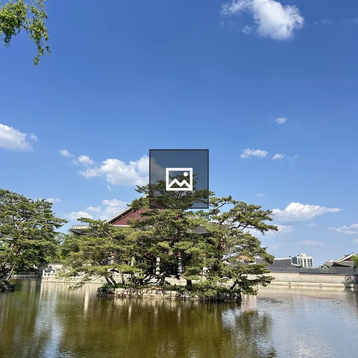 Serene pond with traditional building