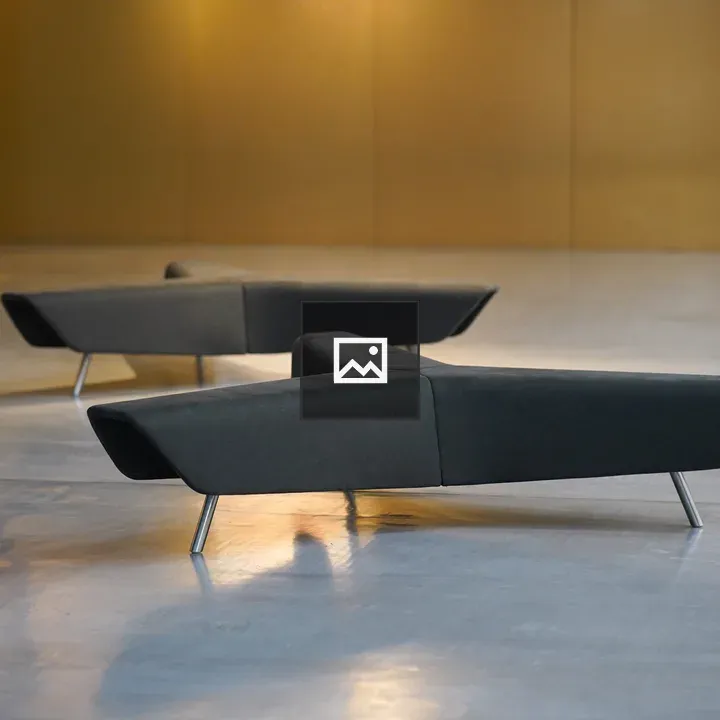 Two modern angular sofas on gray floor