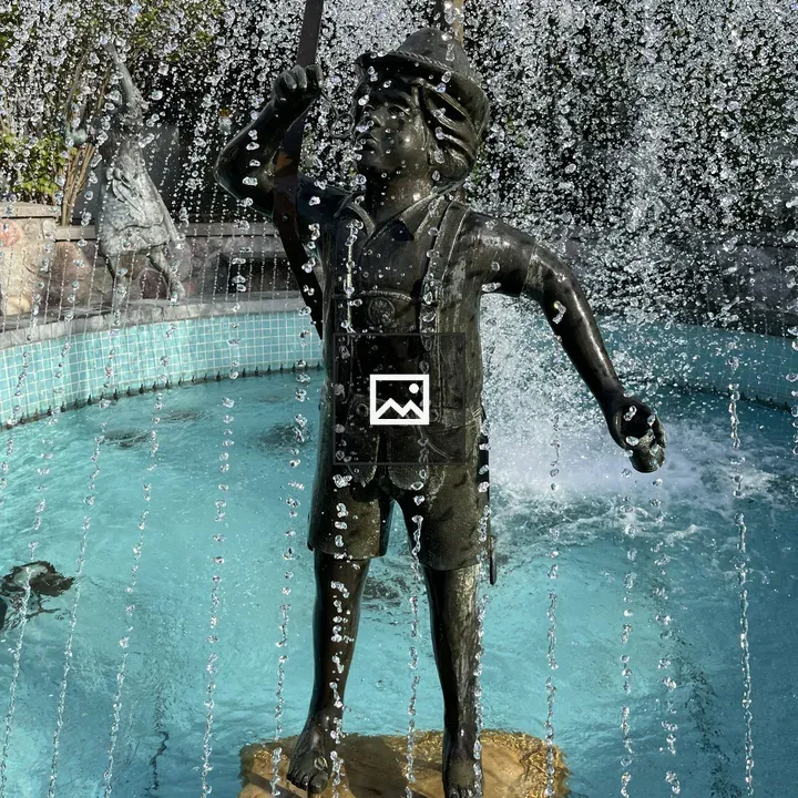 Statue of a Boy Under a Fountain