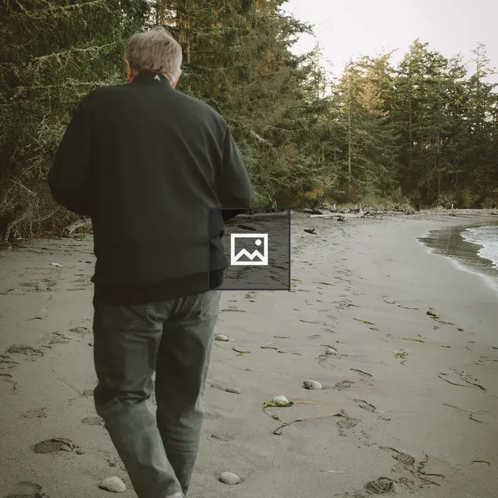 Man Walking on Sandy Beach