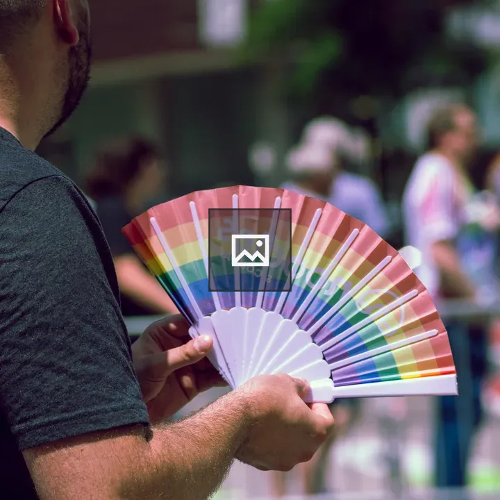 Person with Rainbow Fan at Pride Event
