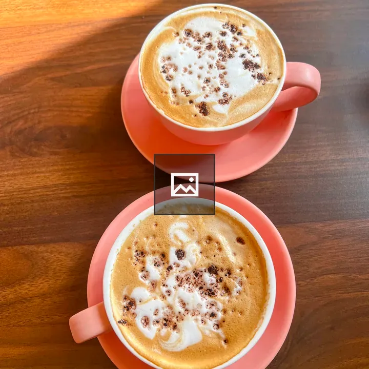 Two cappuccinos in pink cups