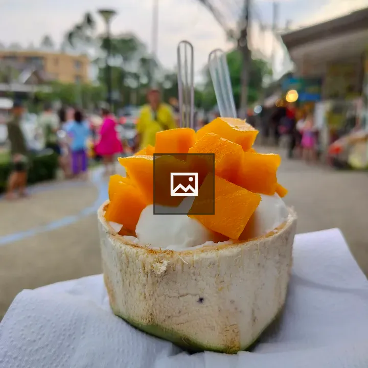 Ice cream with mango in coconut shell