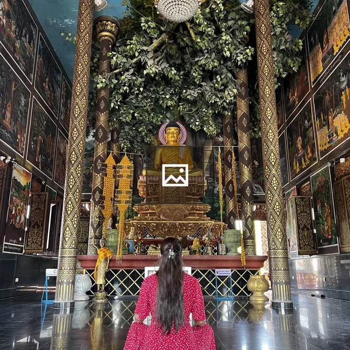 Person in red dress at temple