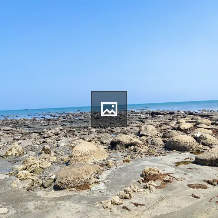 Rocky beach shoreline with blue water