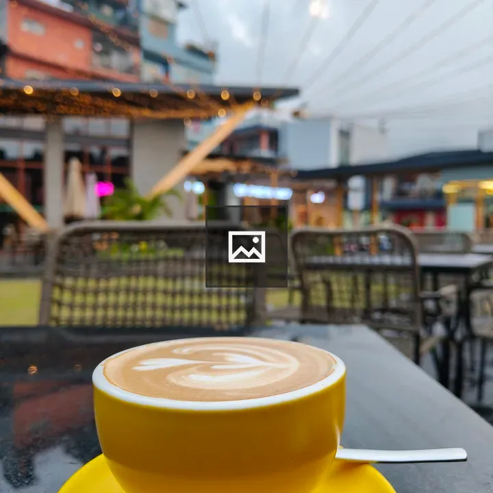 Yellow latte on cafe table