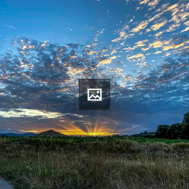 Sunset landscape with sunbeams