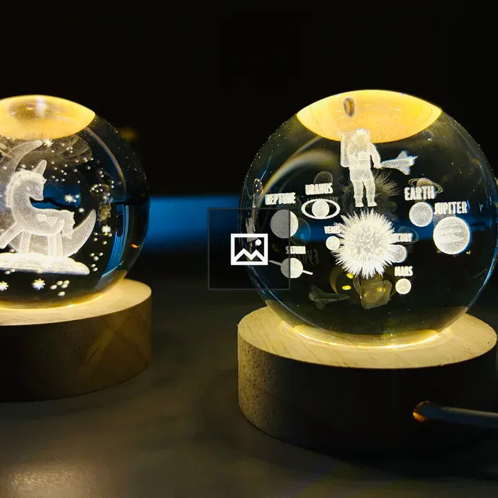 Illuminated crystal spheres with celestial engravings