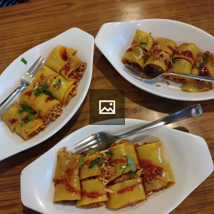 White plates with rolls and noodles