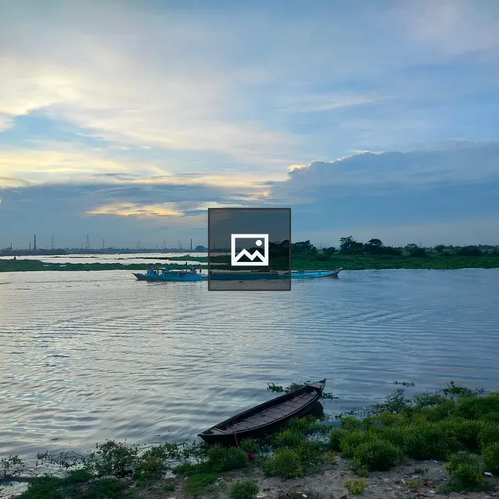 Serene river scene with boats at dusk