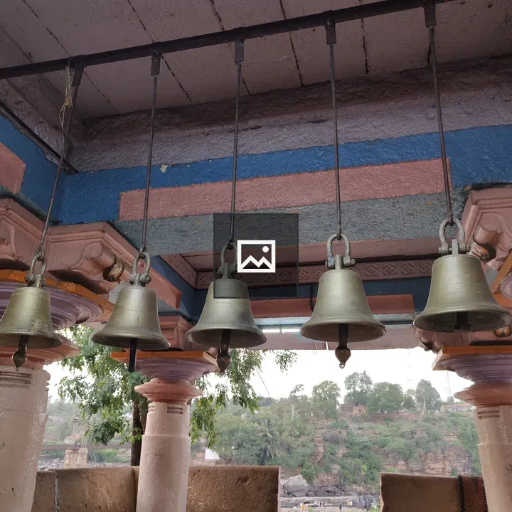 Row of Brass Bells in Blue Pink Ceiling
