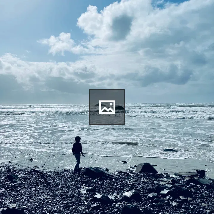 Rocky beach with child looking out