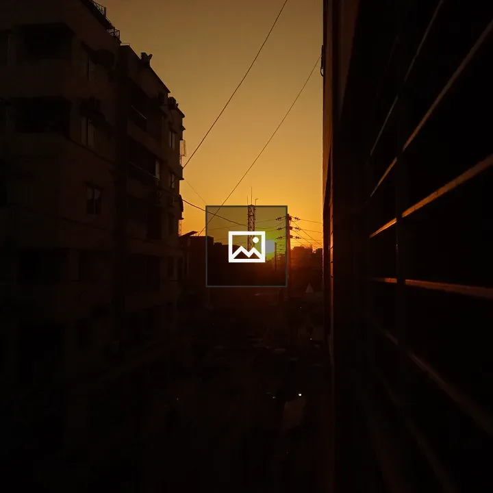Sunset Between Buildings with Power Lines