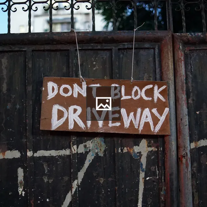 Handwritten Sign on Metal Gate
