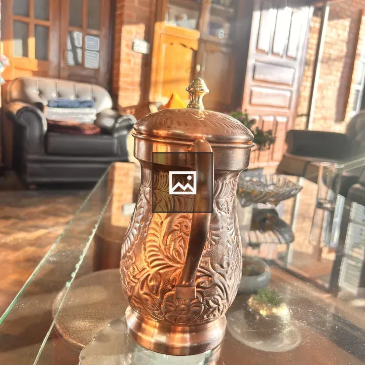 Copper jug with floral engravings