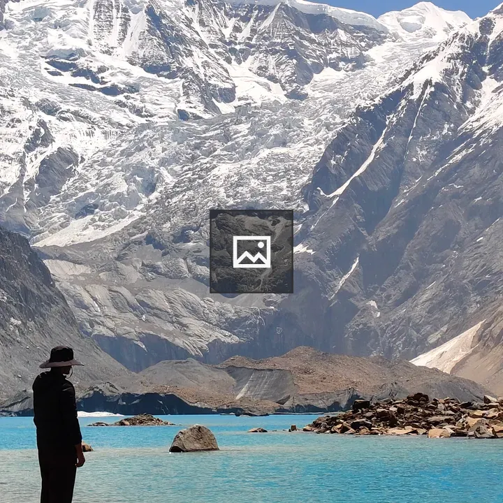 Person by turquoise lake