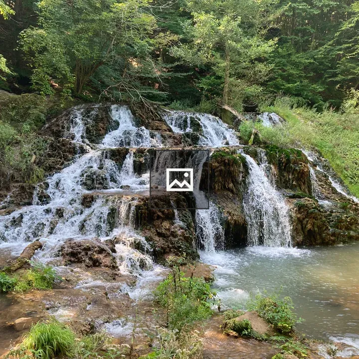Serene waterfall over rocky ledges