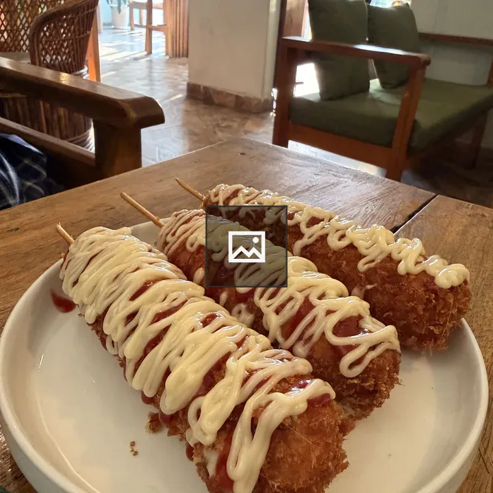 Corn dogs on sticks with toppings
