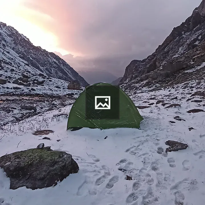 Green tent in snowy mountains