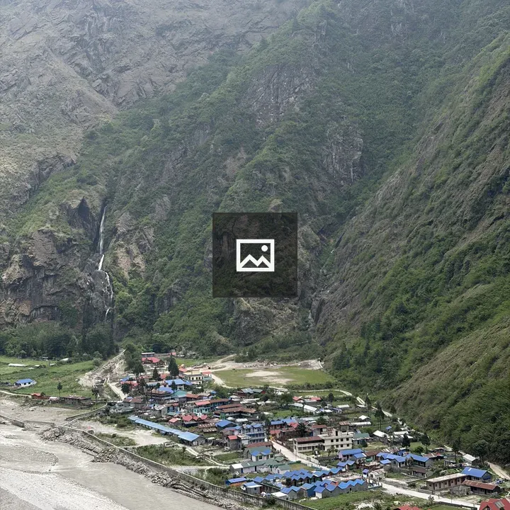Village rooftops in green valley