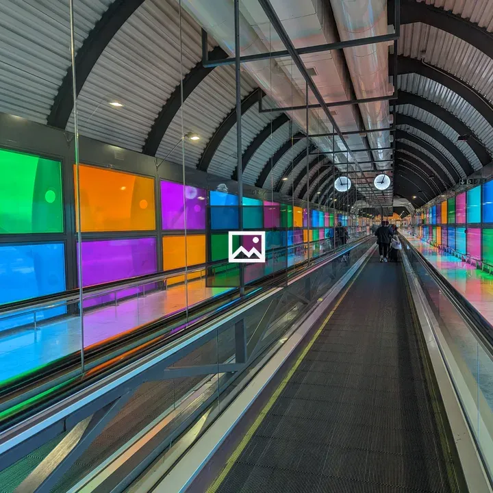 Moving walkway with glass panels