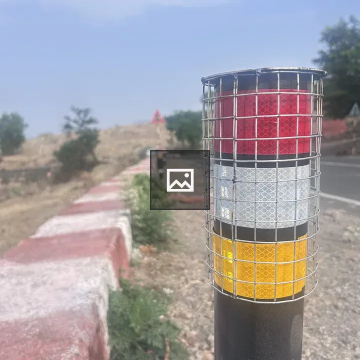 Reflector post by roadside with barriers