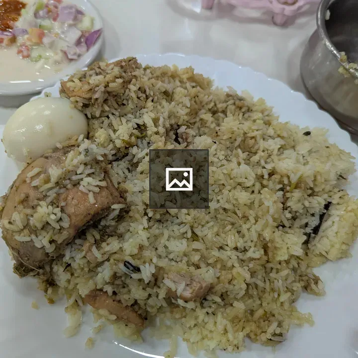 A white plate of biriyani