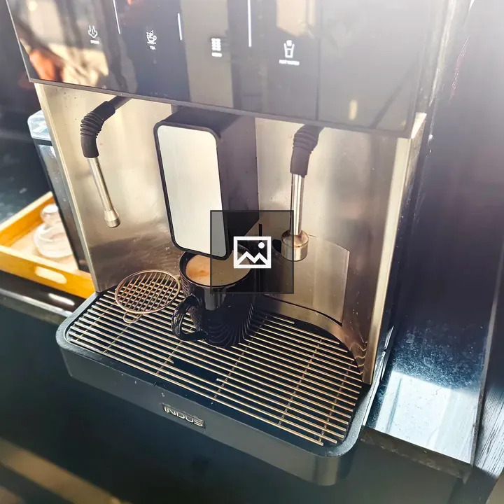 Coffee machine dispensing into mug