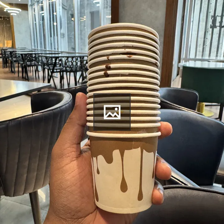 Hand holding chocolate-drip cups