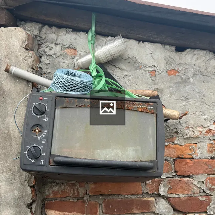 Rusty toaster on brick wall