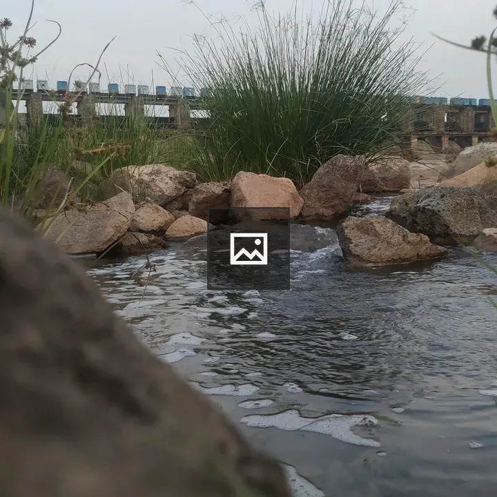 Riverside rocks and dam scene
