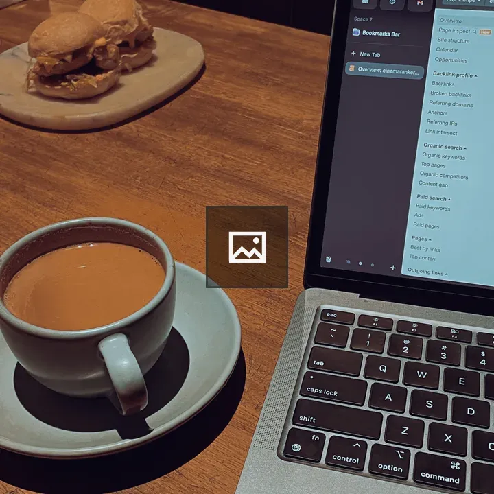 Cup, Laptop, and Burger on Table