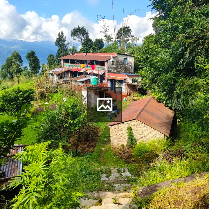 H hillside village building with red roof