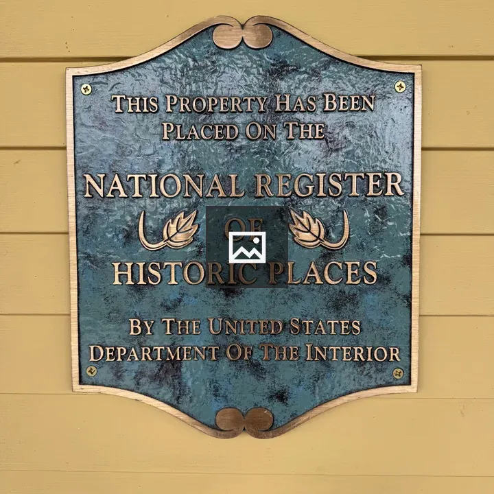 Green plaque on yellow wall