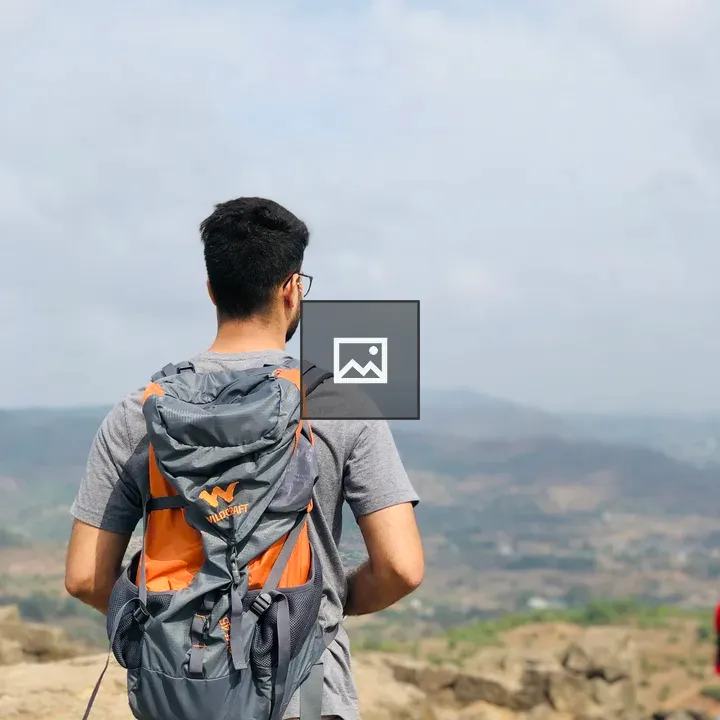 Person with orange bag in landscape
