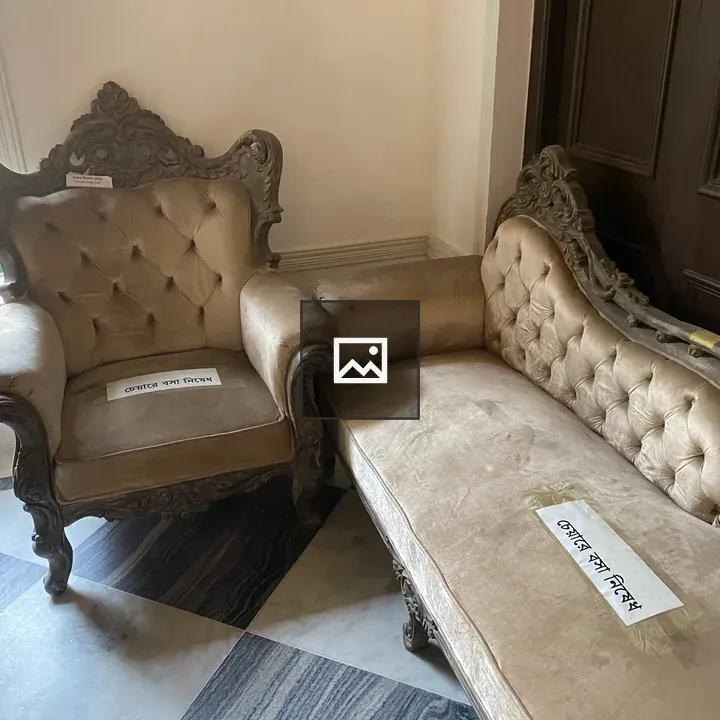 Ornate beige armchair and sofa
