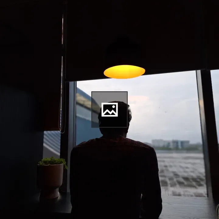 Man under a light looking to horizon