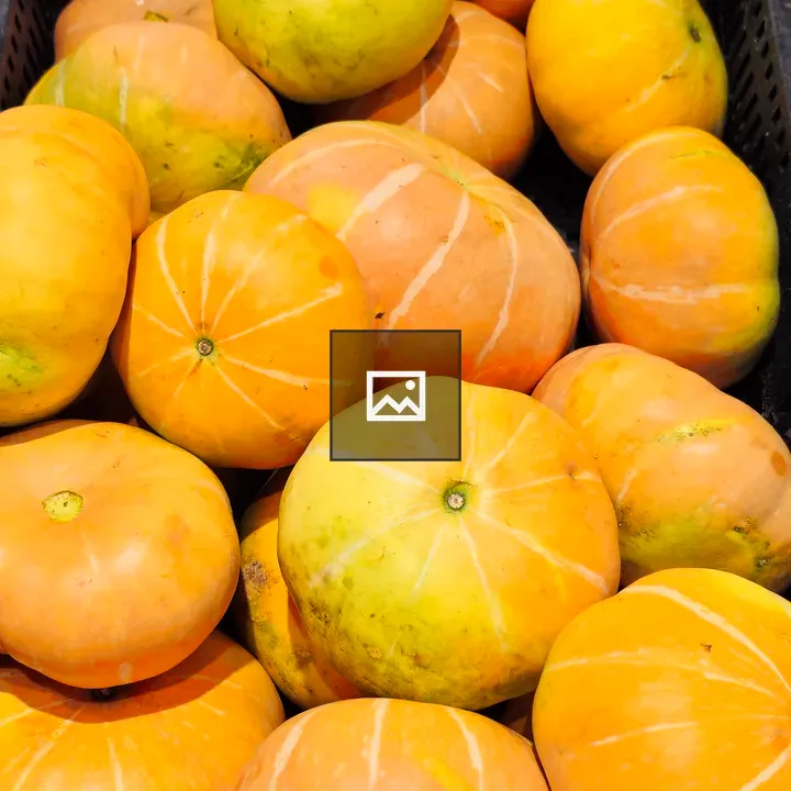 Round yellow pumpkins in crate