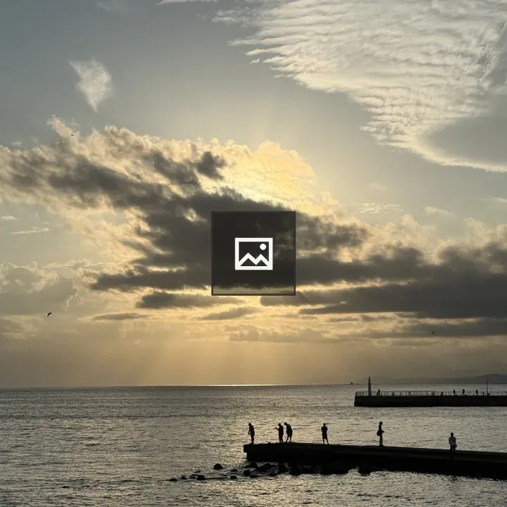 People on a pier at sunset
