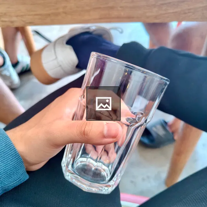 Hand Holding Glass with Hexagonal Base