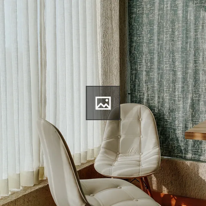 Two white cushioned chairs