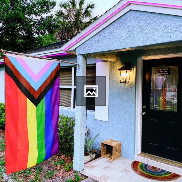 Pride flag by blue house
