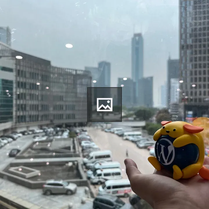 Wapuu in front of window