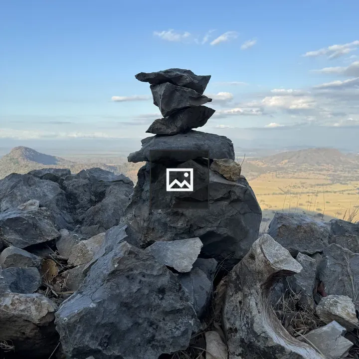 Stacked rocks cairn on mountain viewpoint