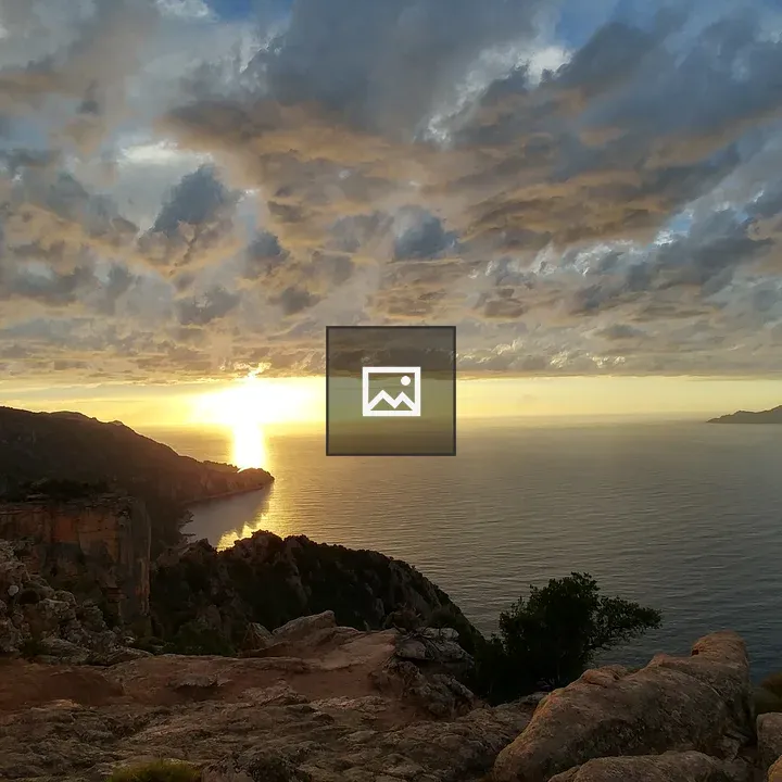 Sunset over the ocean with cliffs