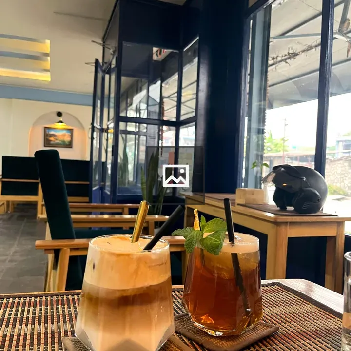 Two layered iced drinks in hex glasses